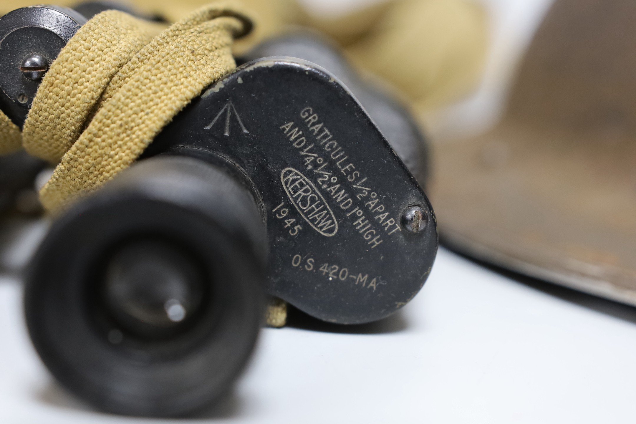 A British WWII military helmet and a pair of Kershaw military binoculars No. 326750